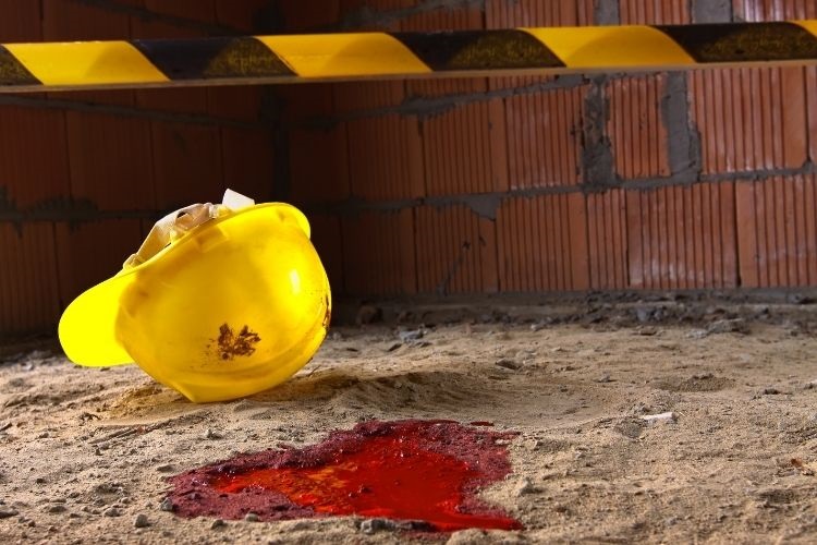 Workplace Accident - hardhat on floor with a puddle of blood